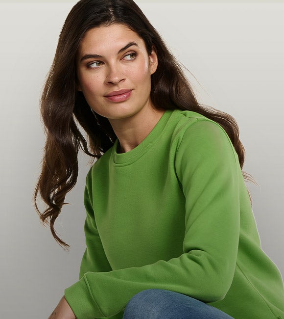 Woman wearing the new basic sweatshirt in sea green.