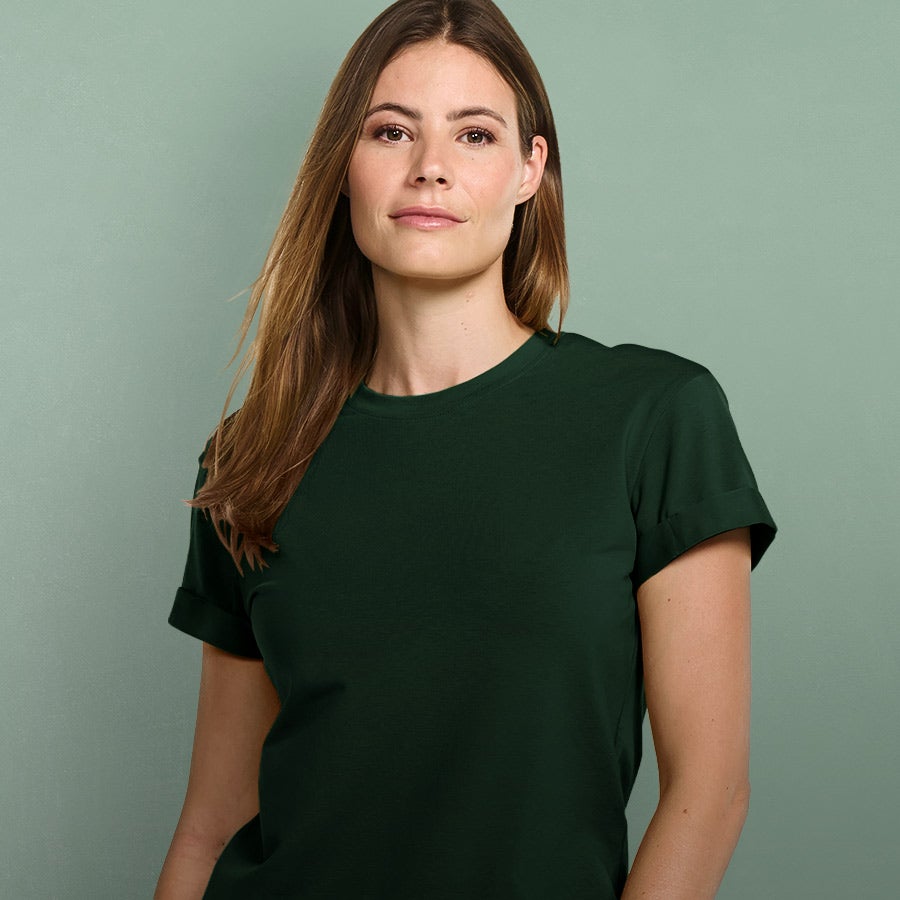 Woman wearing a high-quality T-shirt in green.