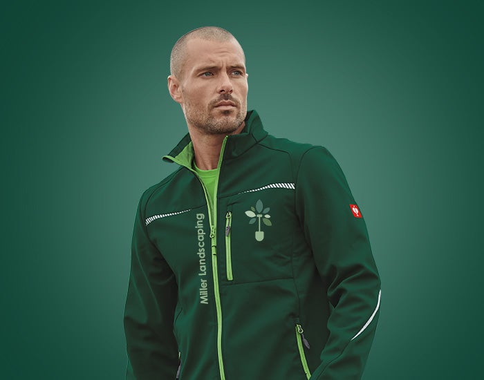 Man wearing a green softshell jacket by Strauss.