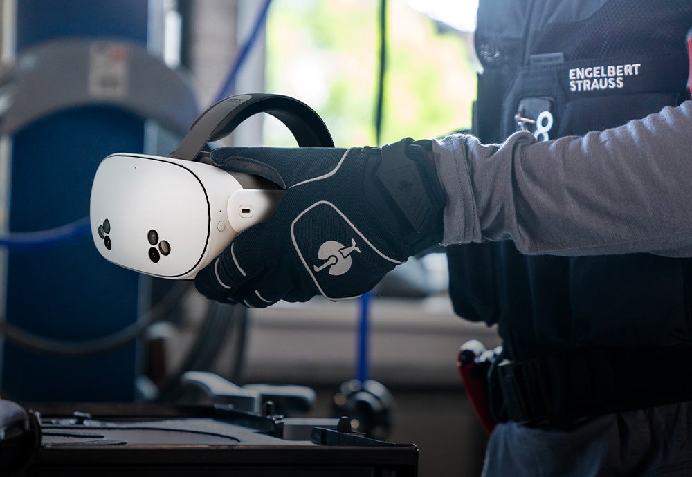 A craftsman takes the Meta Quest 3S out of the STRAUSS box.