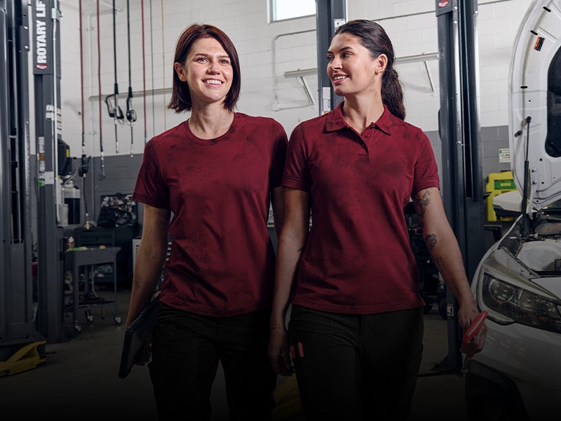 Two women in teamwear look wearing shirts from the e.s.industry collection.