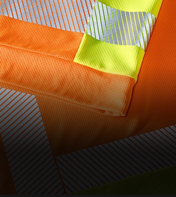 High-vis functional T-shirt e.s.motion 2020 in orange and yellow with reflective stripes.