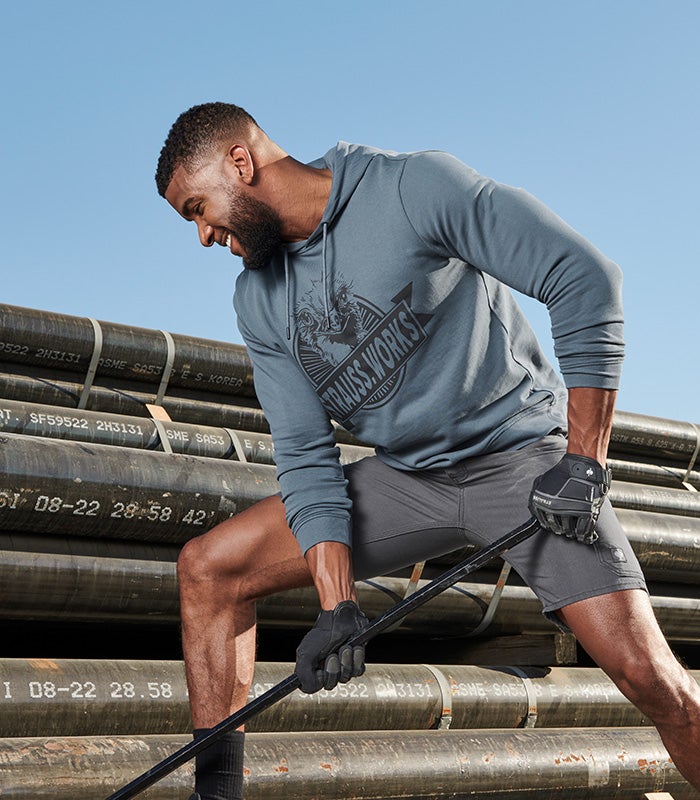 Man wearing a hoody sweatshirt with Strauss print in oxide blue