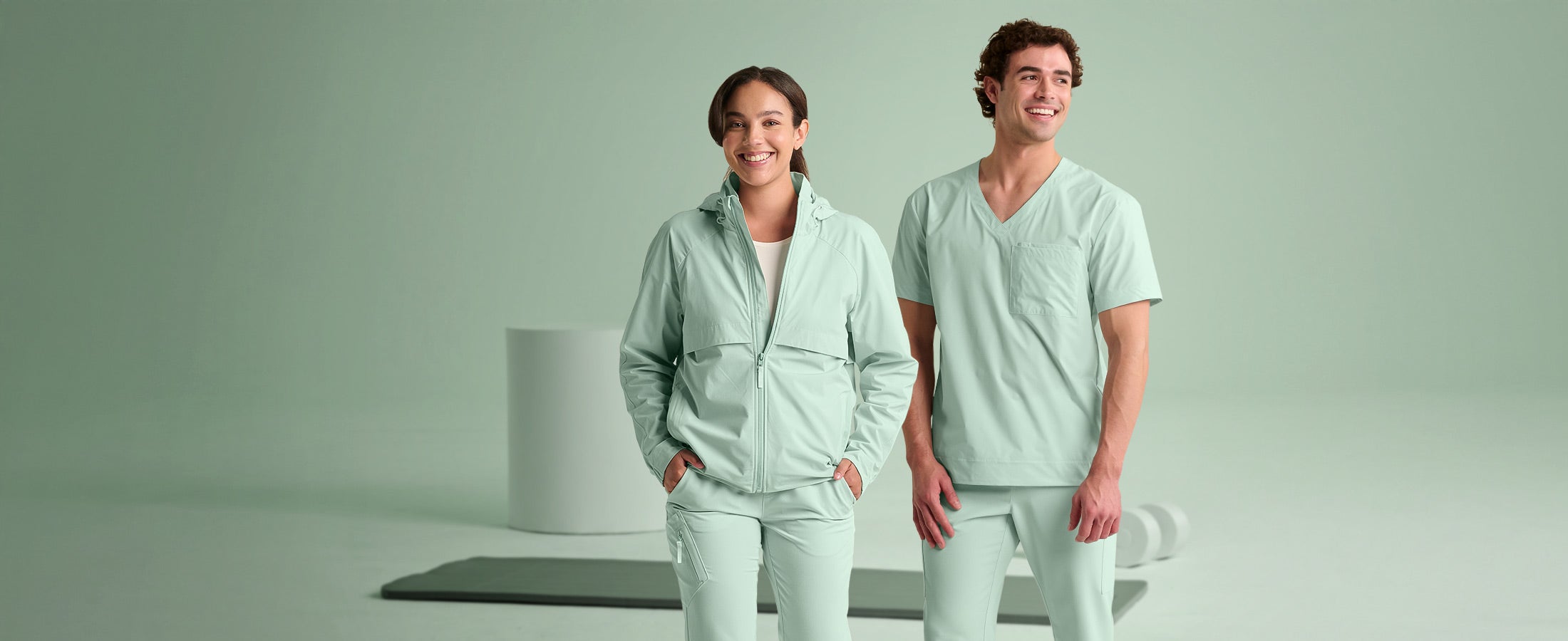 A woman and man wearing the new e.s.avida collection in soft green.