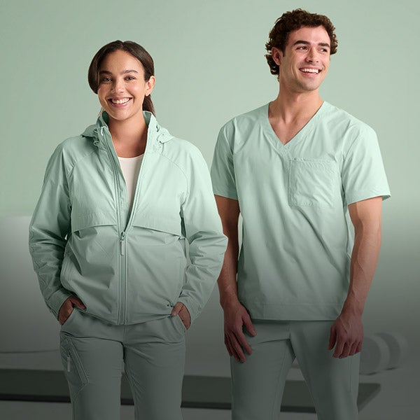 A woman and man wearing the new e.s.avida collection in soft green.