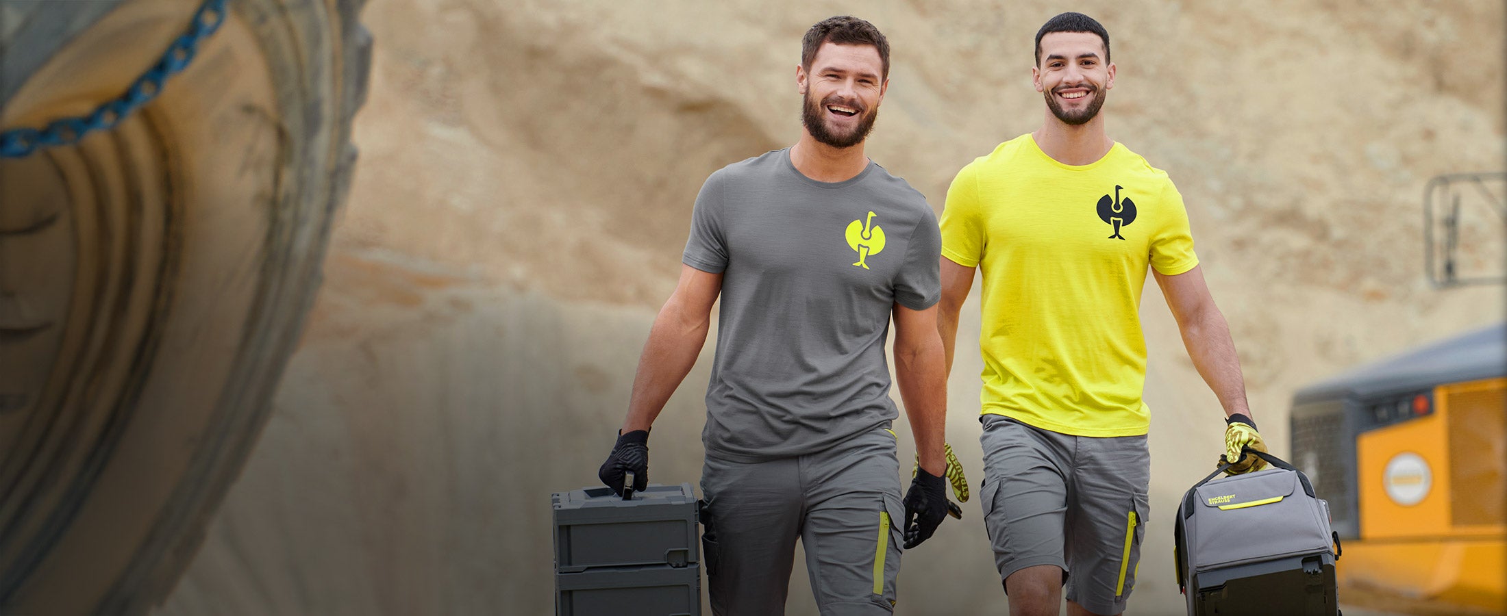 Two men wearing summer clothing from the e.s.trail collection in grey and yellow.