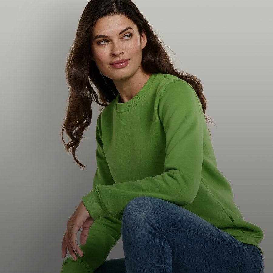 Woman wearing the new basic sweatshirt in sea green.