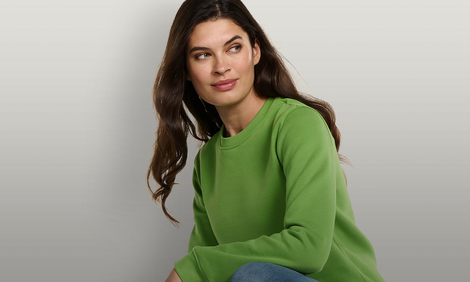 Woman wearing the new basic sweatshirt in sea green.