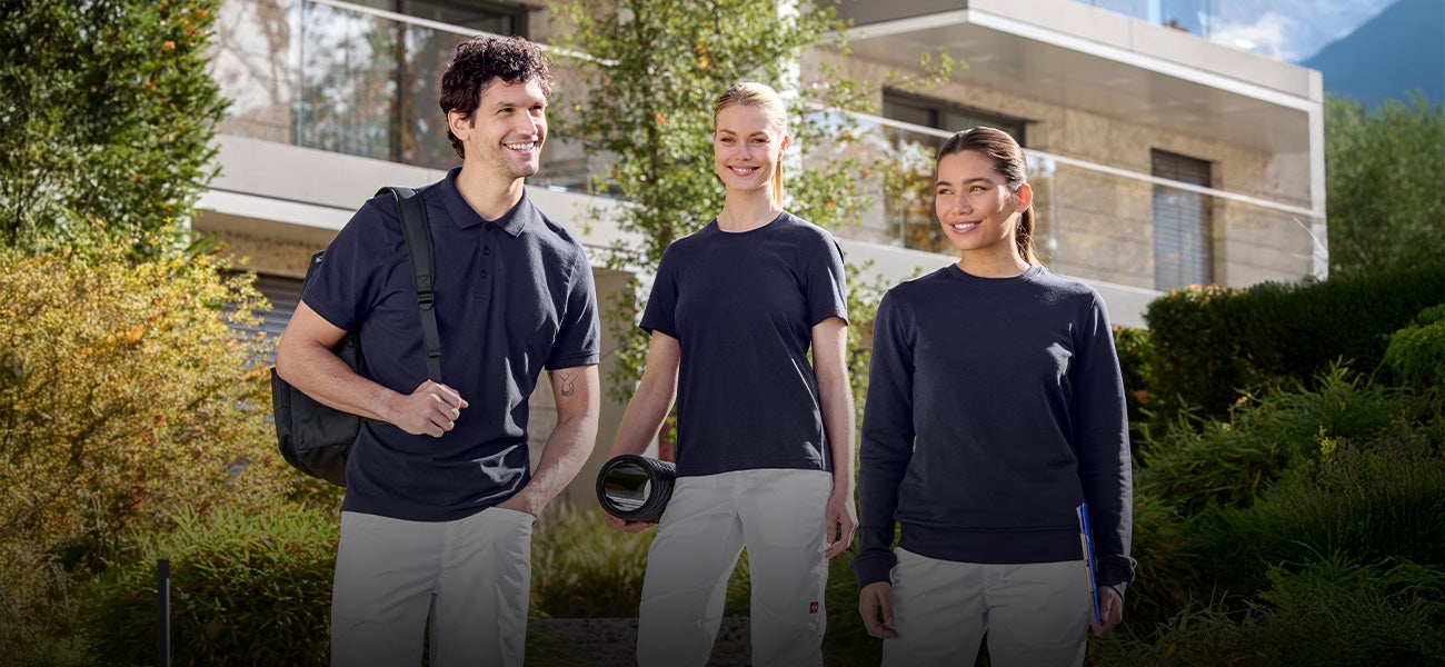 Three people in workwear in the medical sector